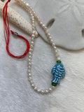 Fish and pearls necklace